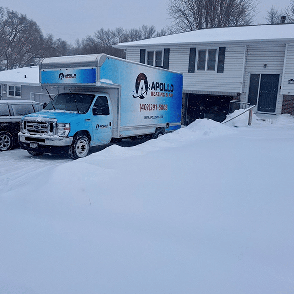company van outside of home in snow